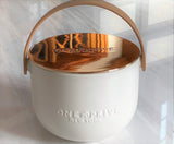 Indulge in the Bergamot and Clove Perfumed Estate Candle from One Preevay. Handcrafted with premium essential oils and soy wax, it features a stunning porcelain bowl with a silver-plated lid and leather strap. Elevate your ambiance with shiny silver finish