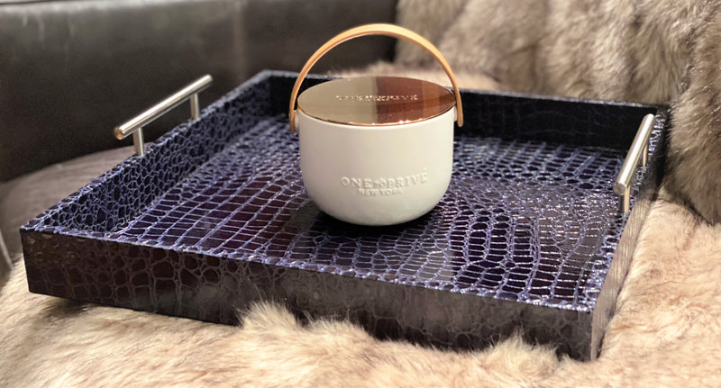 Indulge in the Bergamot and Clove Perfumed Estate Candle from One Preevay. Handcrafted with premium essential oils and soy wax, it features a stunning porcelain bowl with a silver-plated lid and leather strap. Elevate your ambiance for the holidays