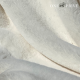  the One Preevay Faux Rabbit Fur Throw in Pure White. Inspired by the elegance of Fernando Botero and crafted from ultra-premium faux rabbit fur. Hypoallergenic, cruelty-free, over the sofa very white