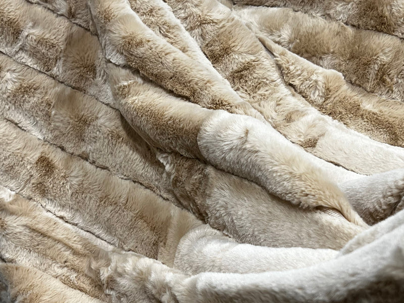 Ribbed Faux Rabbit & Velvet Blanket Collection by One Preevay Luxury Home Furnishings & Decor. Inspired by the regal Robe Royal, each hand-stitched piece features premium cruelty-free faux rabbit fur with elegant velvet underside, available in four luxurious colors: Elegant Black, Warm Beige, Classic Navy, and Dramatic Gray. Sizes: Twin (60" x 90"), Queen (90" x 90"). Hypoallergenic, soothing ribbed design for relaxation and easy care. Cruelty-free luxury, unmatched craftsmanship and detail beige.