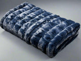 Ribbed Faux Rabbit & Velvet Blanket Collection by One Preevay Luxury Home Furnishings & Decor. Inspired by the regal Robe Royal, each hand-stitched piece features premium cruelty-free faux rabbit fur with elegant velvet underside, available in four luxurious colors: Elegant Black, Warm Beige, Classic Navy, and Dramatic Gray. Sizes: Twin (60" x 90"), Queen (90" x 90"). Hypoallergenic, soothing ribbed design for relaxation and easy care. Cruelty-free luxury, unmatched craftsmanship and detail in Blue 
