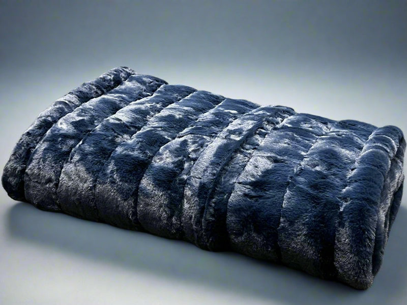 Ribbed Faux Rabbit & Velvet Blanket Collection by One Preevay Luxury Home Furnishings & Decor. Inspired by the regal Robe Royal, each hand-stitched piece features premium cruelty-free faux rabbit fur with elegant velvet underside, available in four luxurious colors: Elegant Black, Warm Beige, Classic Navy, and Dramatic Gray. Sizes: Twin (60" x 90"), Queen (90" x 90"). Hypoallergenic, soothing ribbed design for relaxation and easy care. Cruelty-free luxury, unmatched craftsmanship and detail in Blue Navy....