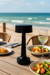 Discover the Grace Hospitality Tabletop Lamp in sleek black from One Preevay. Cordless, rechargeable, and water-resistant, this lamp offers effortless ambiance and dimming control. Perfect for any setting. Order now to elevate your space with elegance and style.
