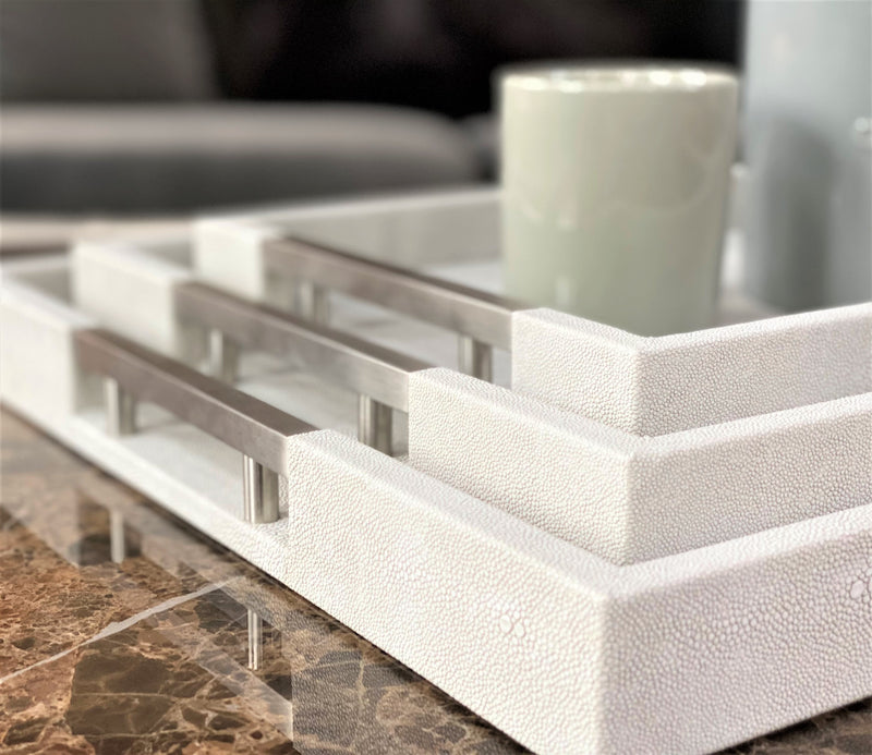 Discover the Thursby Shagreen Hotel Tray from One Preevay—a luxurious serving tray crafted with exotic embossed leather and nickel hardware. Available in three sizes: 17"x10", 20"x13", and 23"x15". Elevate your entertaining experience with sophistication and style. Order now..
