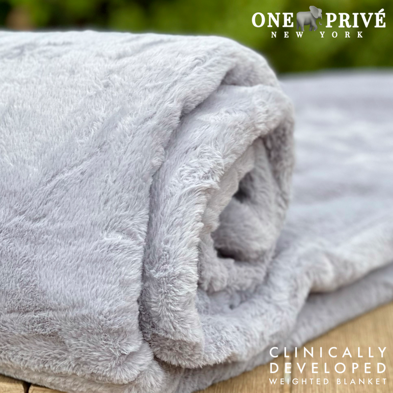 Experience luxurious relaxation with One Preevay's world's first weighted faux rabbit fur blanket, inspired by Fernando Botero. Clinically developed, 20lbs, hypoallergenic, and luxurious for serene sleep & relaxation.